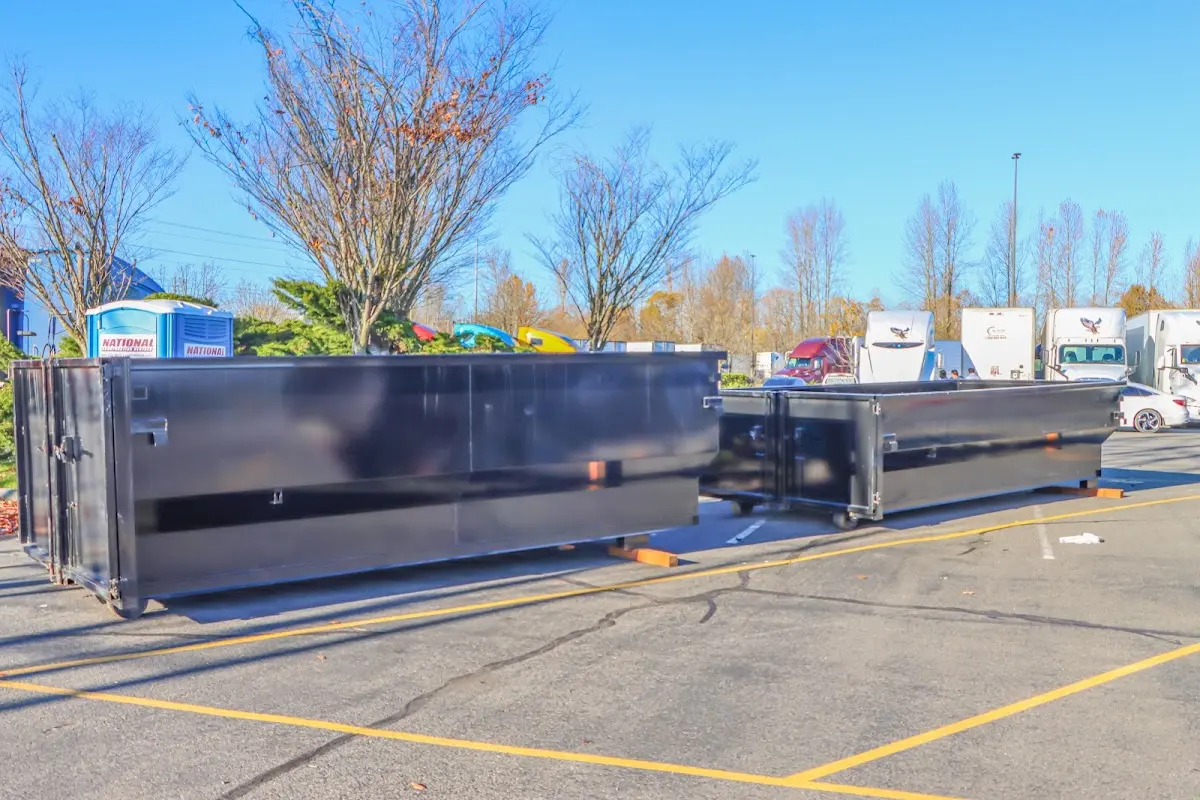 Professional dumpster rental service with roll-off container on residential driveway in Ettrick